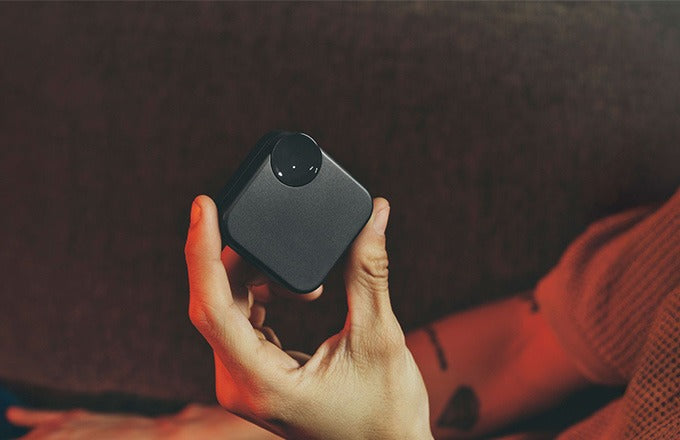 A user holding the CTRL8 Ultra Pro earbuds case, showcasing its compact design and premium finish