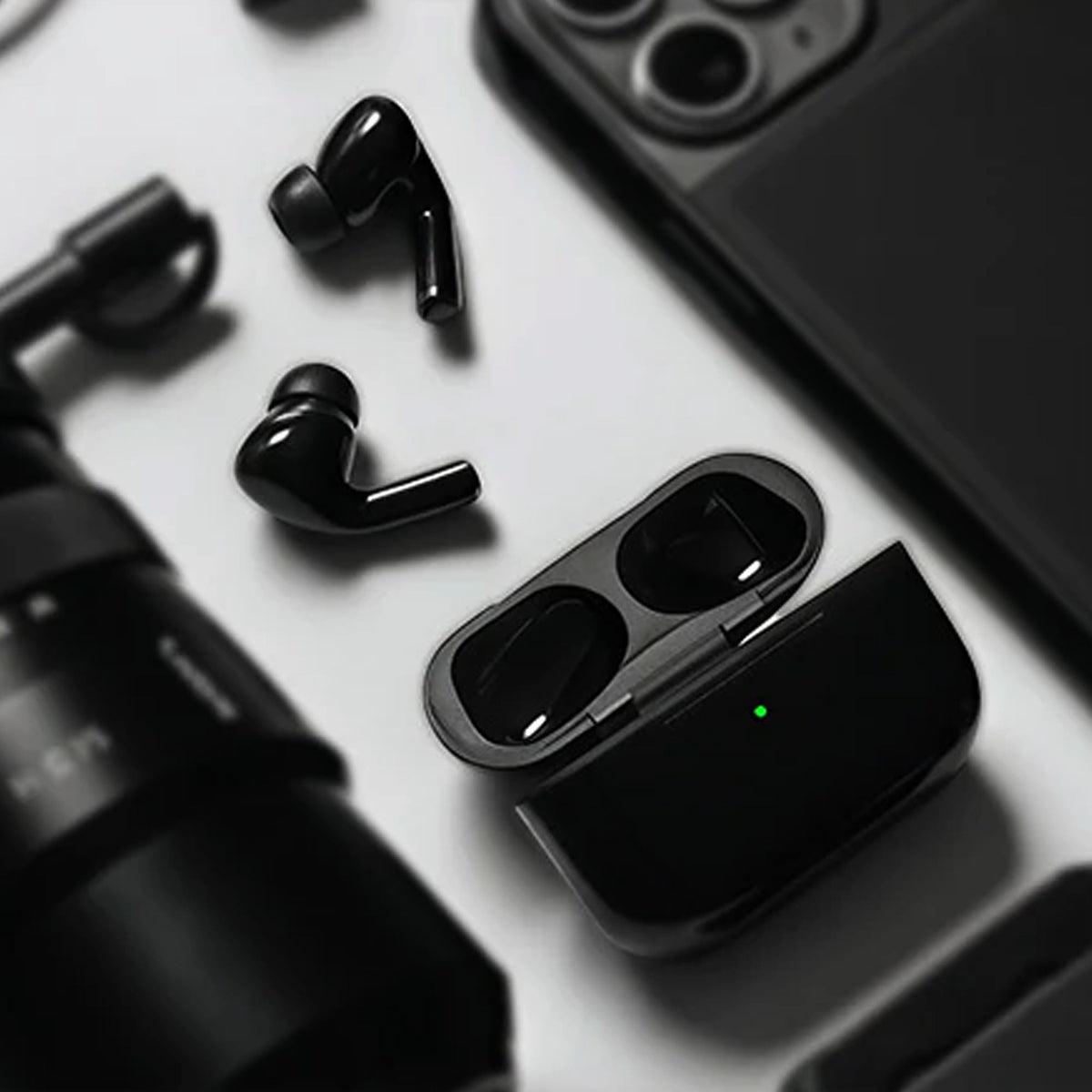CTRL8 Wireless Airpods Pro 2 placed alongside tech accessories, showcasing sleek design and portability