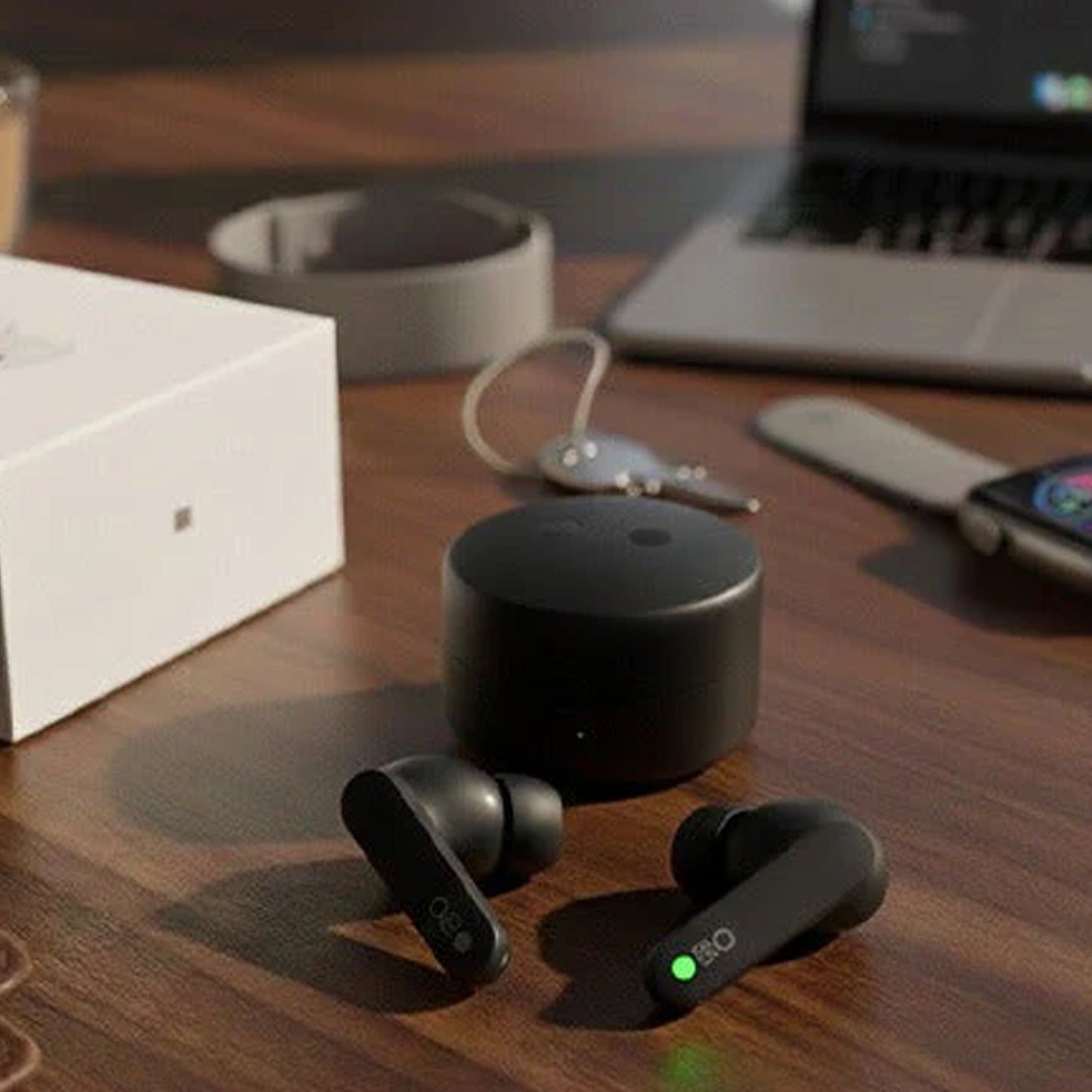CTRL8 wireless earbuds with 12-hour playtime on a desk alongside a laptop and accessories