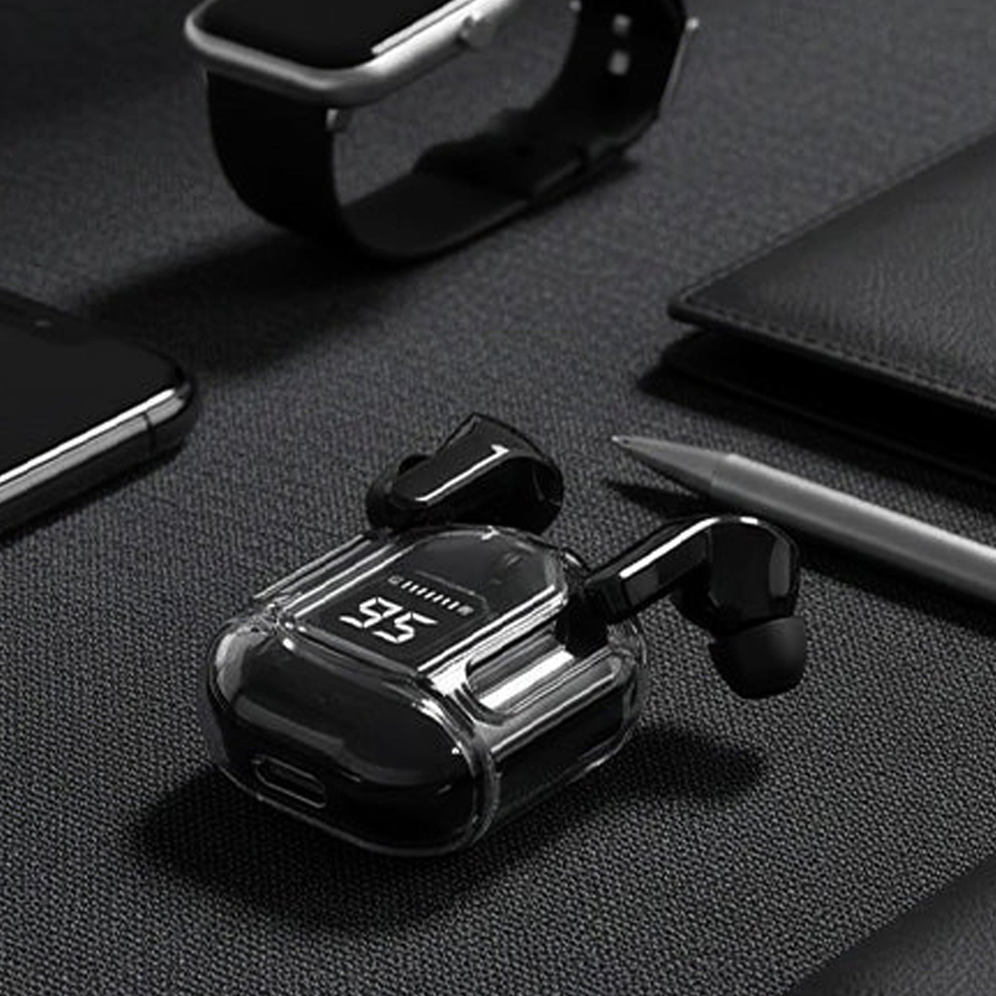 CTRL8 true wireless earbuds UB with transparent case and digital display placed on a desk with accessories