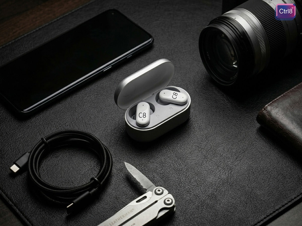 CTRL8 2R true wireless stereo earbuds displayed with charging case in a professional workspace setup