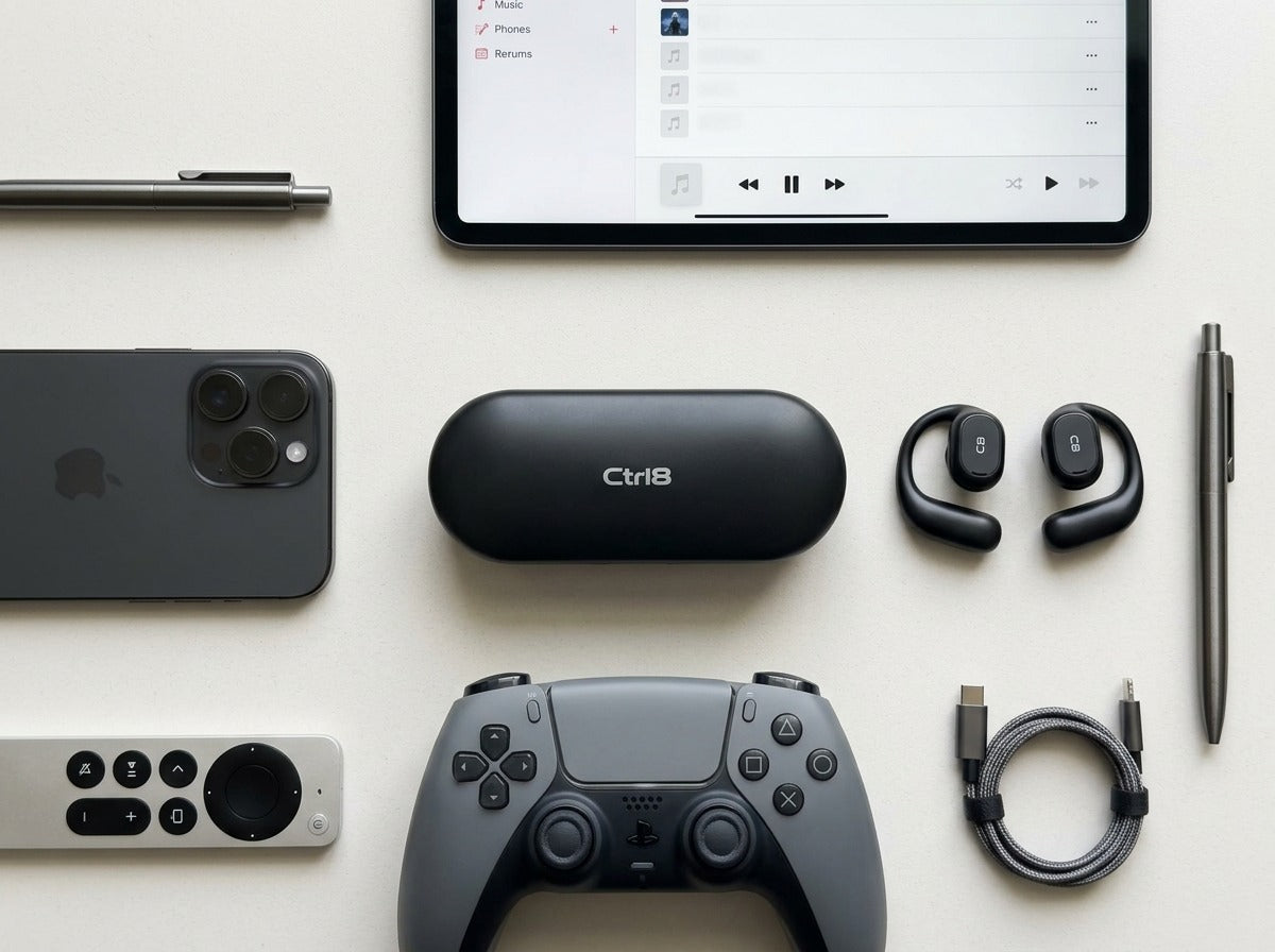 CTRL8 X29 open-ear headphones with charging case placed alongside gaming and tech accessories for immersive audio experience
