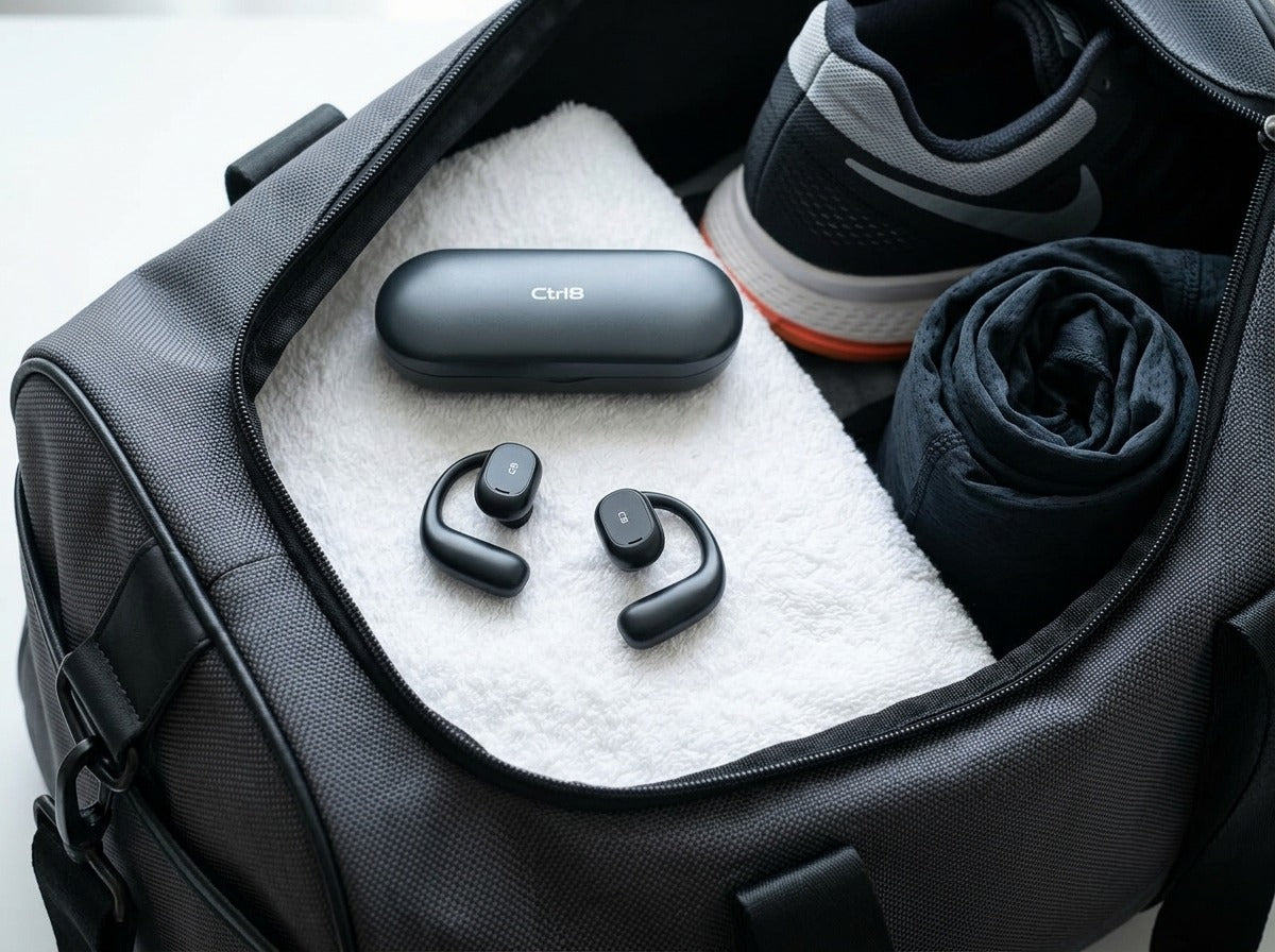 CTRL8 X29 open-ear headphones with charging case placed in a gym bag for fitness enthusiasts