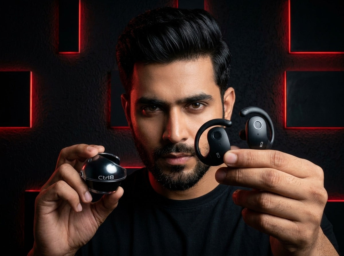 User holding CTRL8 T2 over-the-ear earbuds with UNBLOQ technology against a black and red illuminated background