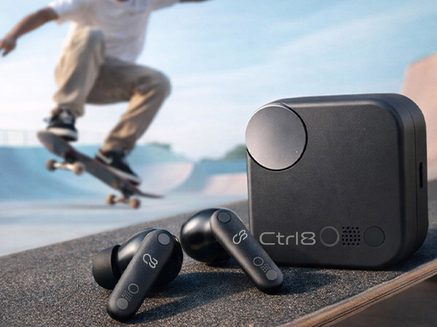 Skater with CTRL8 CMT Ultra Pro true wireless noise-cancelling earbuds and charging case on a skate ramp