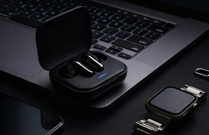 CTRL8 Advanced HiFi true wireless earbuds placed on a desk near a laptop and smartwatch, ideal for work or leisure.